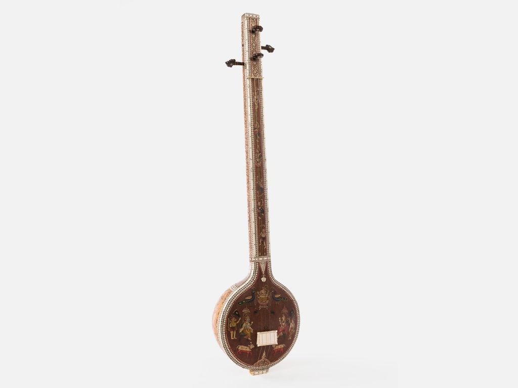 A rare ornately painted tambūrā